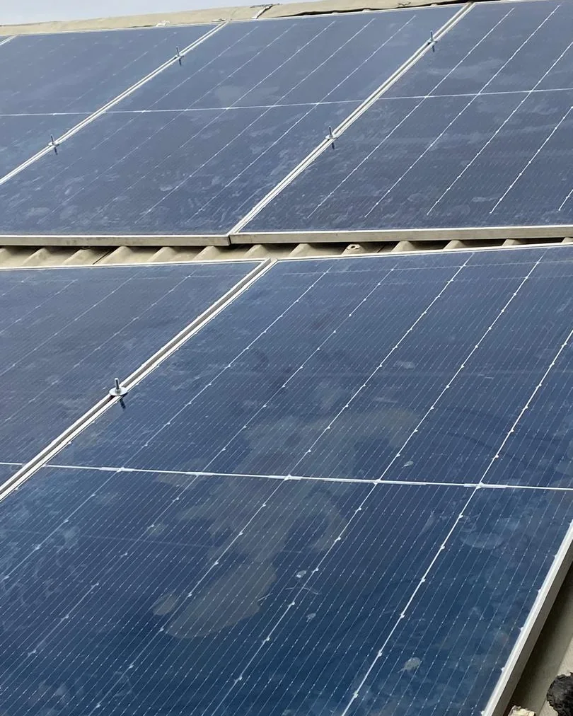 Rooftop solar photovoltaic modules at a residential project in Badore